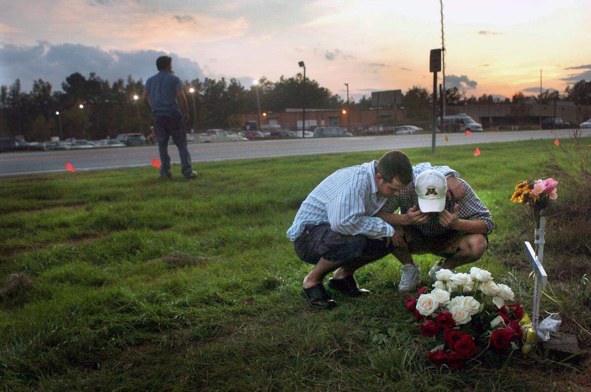 Jeff McEldowney, left, consoles Charlie Andrews as they mourn their friend and classmate Nolan Myers Nov. 5, 2003 who died while helping at the scene of an accident on Chapel Hill Rd. in Raleigh. The two, and Jonathan Corriere, far left, were suitemates with Myers in a dorm at Campbell University. Five other good samaritans were struck and killed by a van driven by a drunk driver as they were helping at the scene of an accident that happened just minutes before they were killed. "It's been rough, real rough," Corriere said. Another friend and roommate of theirs who was helping at the scene is in the hospital with two shattered legs and several other injuries from the accident caused by the van that killed Myers.