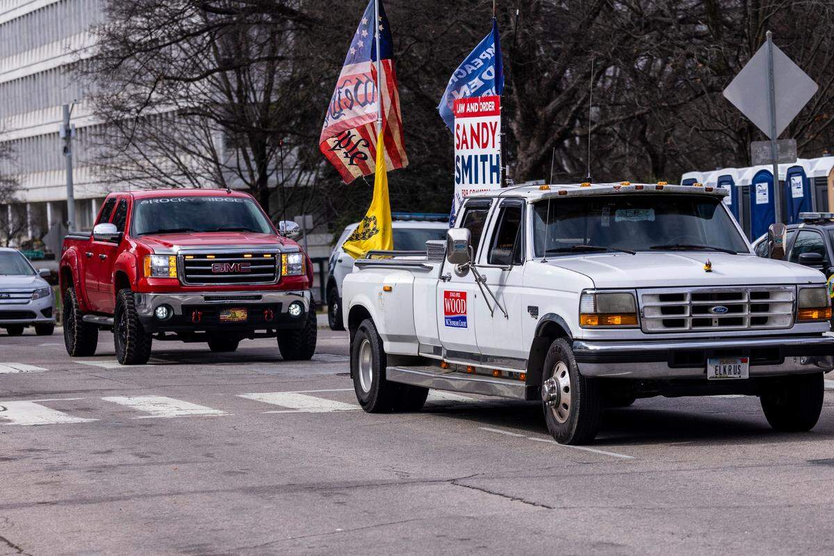A small convoy of demonstrators protesting COVID-19 mandates that included a tractor-trailer arrives on Jones Street in Raleigh Friday, Feb. 25, 2022. Some protesters included about a dozen men dressed in Proud Boy clothing. The demonstration was part of an earlier protest in Mebane that was advertised on social media as a trucker convoy.