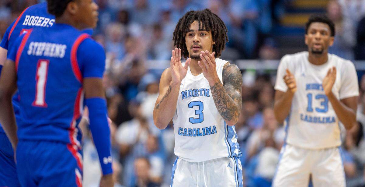 North Carolina guard Elliot Cadeau (3) and forward Jalen Washington (13) applaud an early lead by the Tar Heels in the first half against American University on Friday, November 15, 2024 at the Smith Center in Chapel Hill, N.C.