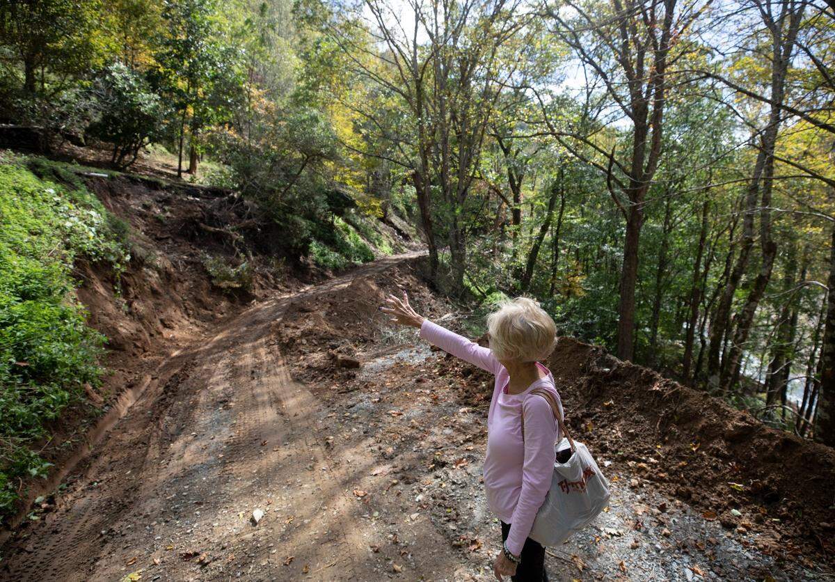 Minneapolis, N.C. resident Della Wright, photographed on Wednesday, Oct. 2, 2024, points to where a mudslide ravaged the mountainside near her home during Hurricane Helene.