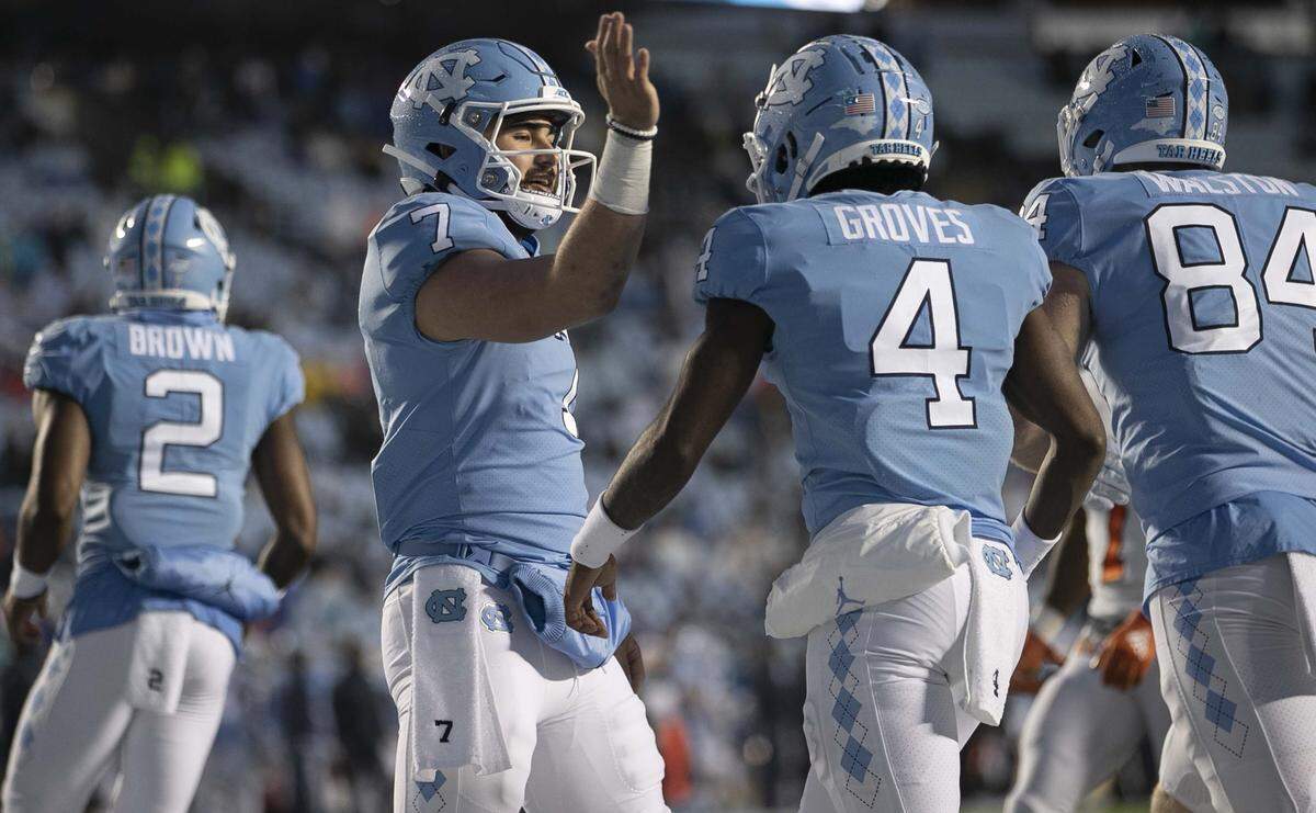 North Carolina quarterback Sam Howell (7) congratulates Toe Groves (4) after a pass reception in the second quarter against Mercer on Saturday, November 23, 2019 at Kenan Stadium in Chapel Hill, N.C.
