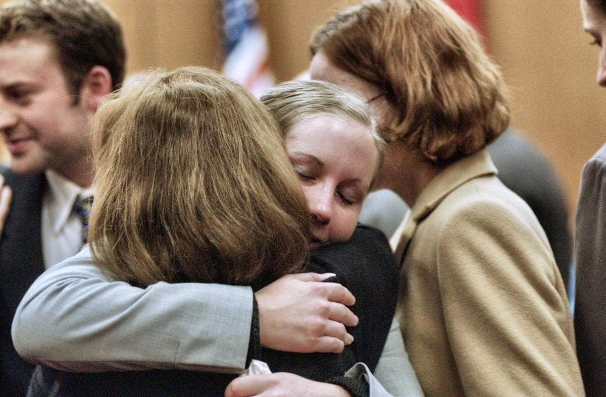 Caitlin Atwater embraces a family member after the first appearance of Michael Peterson Dec. 21, 2001.