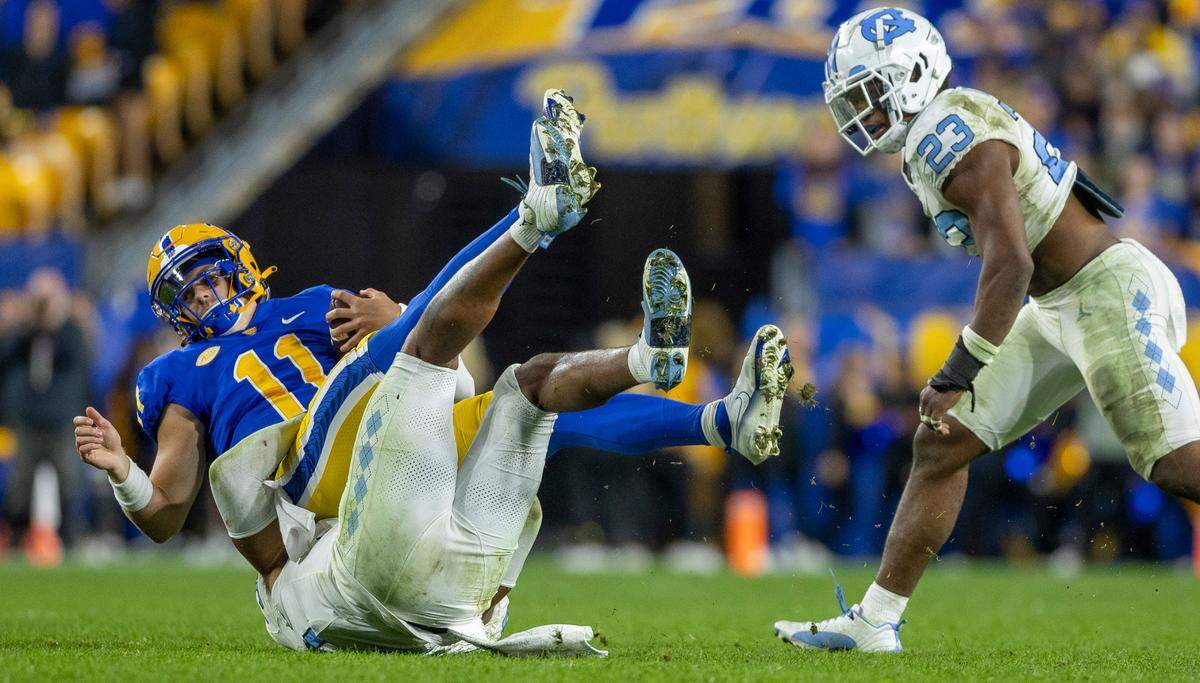 North Carolina’s Cedric Gray (33) stops Pitt quarterback Christian Veilleux (11) after a three-yard gain in the third quarter on Saturday, September 23, 2023 at Acrisure Stadium in Pittsburgh, Pa.