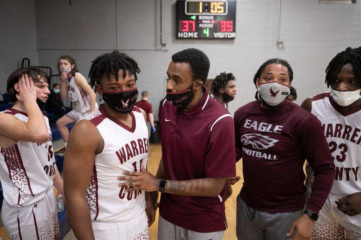 Warren County High School coach Toriano McRae Jr. has a word with Jah’Quell Hendrick (11) during the closing minute of play against Bunn High School on Tuesday, February 2, 2021 in Warrenton, N.C.