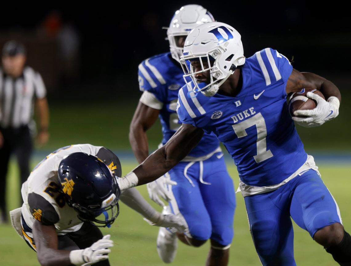 Duke Blue Devils running back Jordan Waters fends off North Carolina A&T Aggies defensive back Ty Williams Jr. during the second half of Dukes game against North Carolina A&T at Wallace Wade Stadium in Durham, N.C. on Saturday, Sept. 17, 2022.