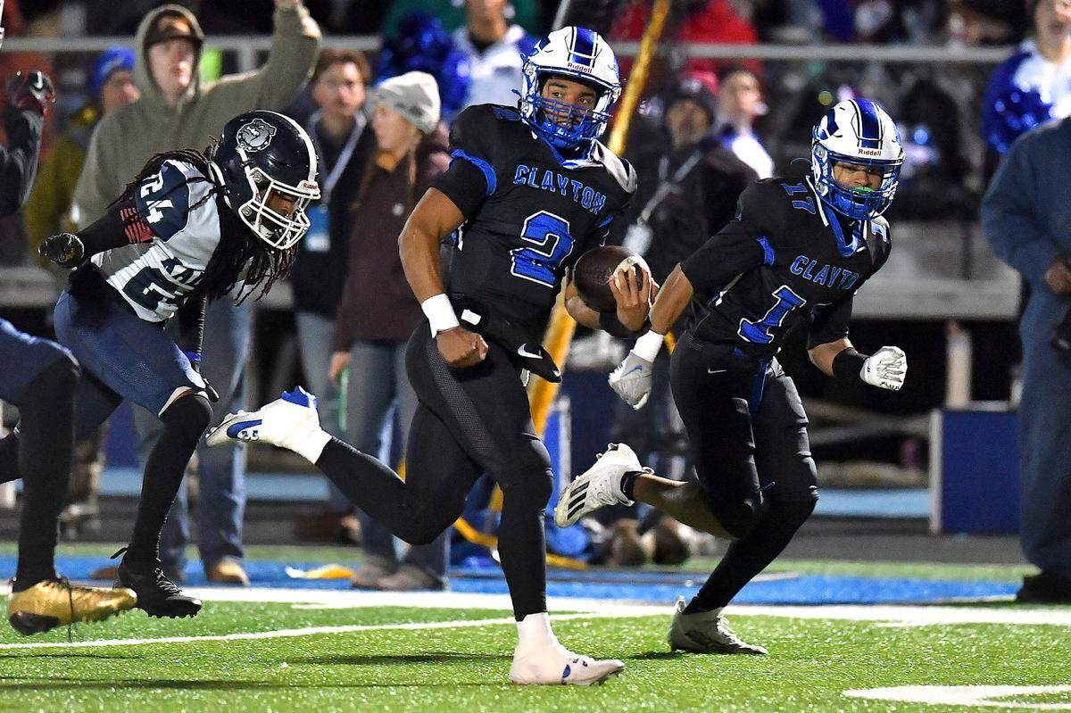 Clayton quarterback Aiden Smalls (2) sprints for the touchdown against Southeast Raleigh during the first half.  The Clayton Comets and the Southeast Raleigh Bulldogs met in the fourth round of the NCHSAA 7A Playoffs in Clayton, North Carolina, on Nov. 28, 2025.