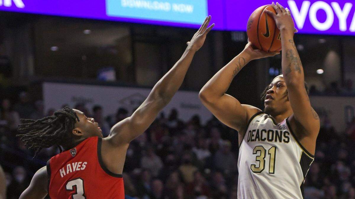 Wake Forest’s Alondes Williams sinks a step-back jumper over North Carolina State’s Cam Hayes during an NCAA college basketball game Wednesday, March 2, 2022 in Winston Salem, N.C. (Walt Unks/The Winston-Salem Journal via AP)