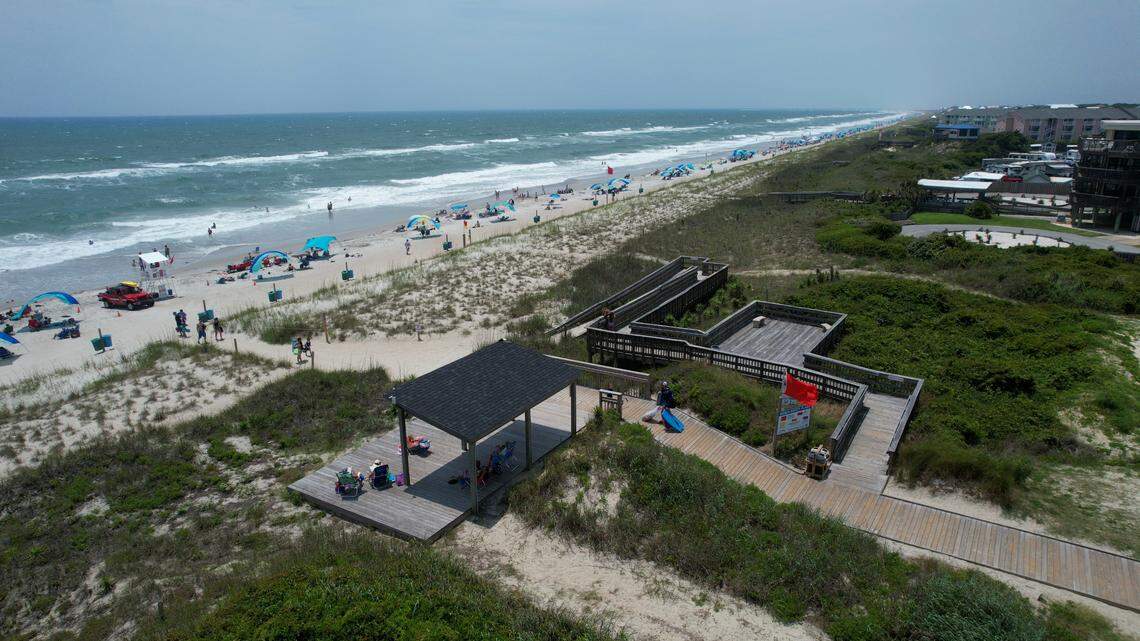 A red flag indicates high risk of powerful currents and rough surf at the Western Ocean Region Access in Emerald Isle.