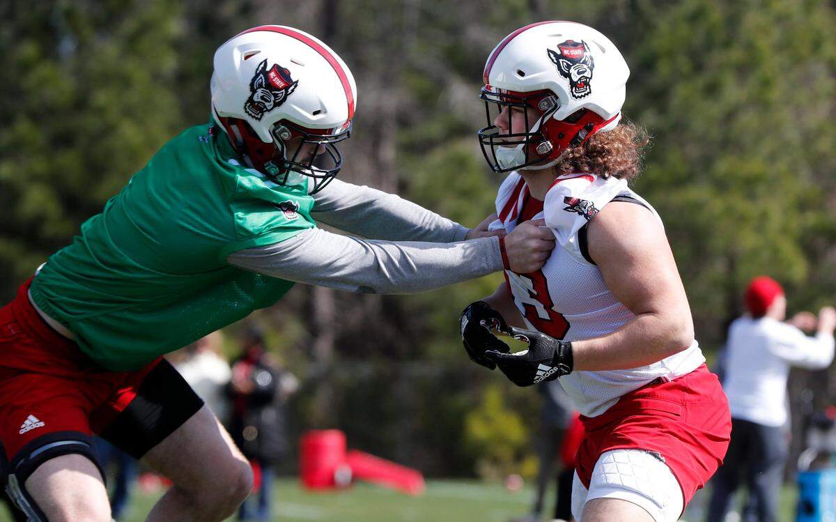 N.C. State linebacker Payton Wilson (11), left, runs drills with linebacker Drake Thomas (13) during N.C. State football’s first day of spring practice Saturday, March 2, 2019.