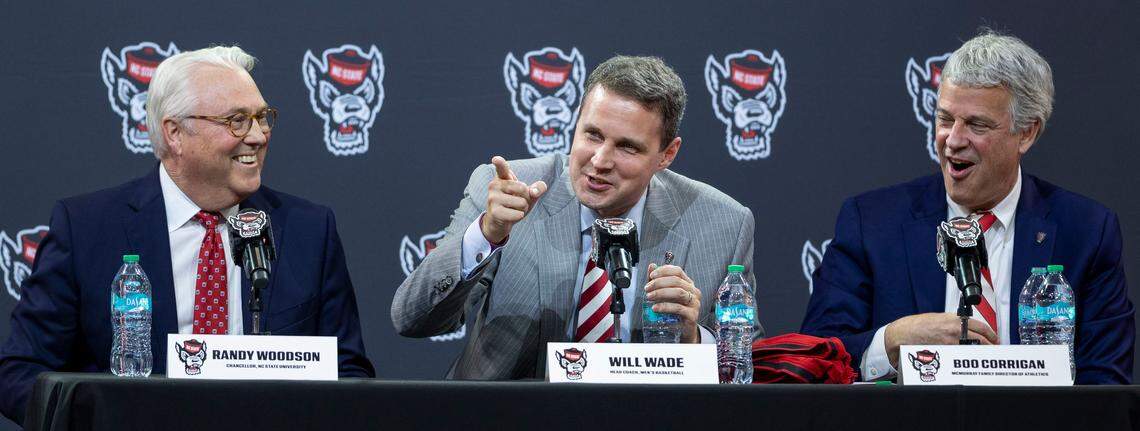 Will Wade, center, flanked by N.C. State Chancellor Randy Woodson and athletic director Boo Corrigan field questions following his introduction at the new Wolfpack men’s basketball coach on Tuesday, March 25, 2025 at Reynolds Coliseum in Raleigh, N.C.