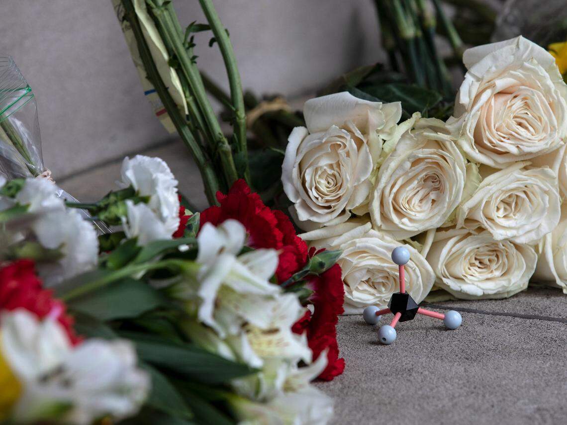 Flowers and a molecular model sit at the base of the bell tower on the campus of UNC-Chapel Hill on Tuesday, Aug. 29, 2023, following a Monday shooting that left a member of the faculty dead.