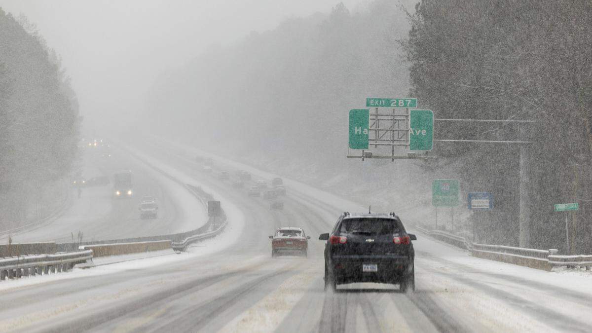 Snow begins to accumulate on I-40 near Harrison Avenue in Cary on Wednesday, Feb. 19, 2024.