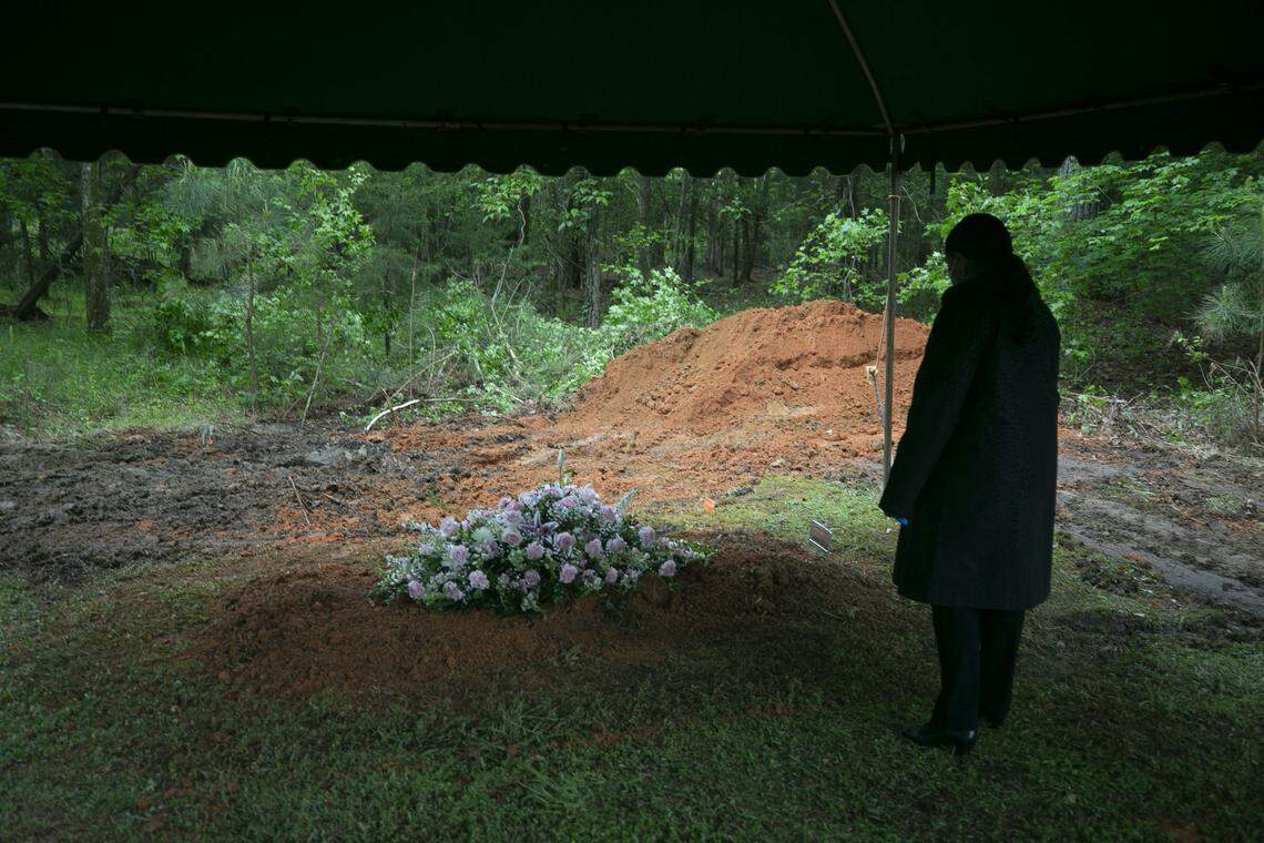 Ernestine Keith takes a few moments to view her mother Cleora W. Mann’s grave following her burial at the family’s home place on Friday, May 1, 2020 in Louisburg, N.C. Mann, age 104, died from the coronavirus virus on Sunday, April 26. She was a resident of Louisburg Healthcare & Rehabilitation Center where 62 positive cases and 18 deaths from the coronavirus were reported by the Franklin County Health Department.