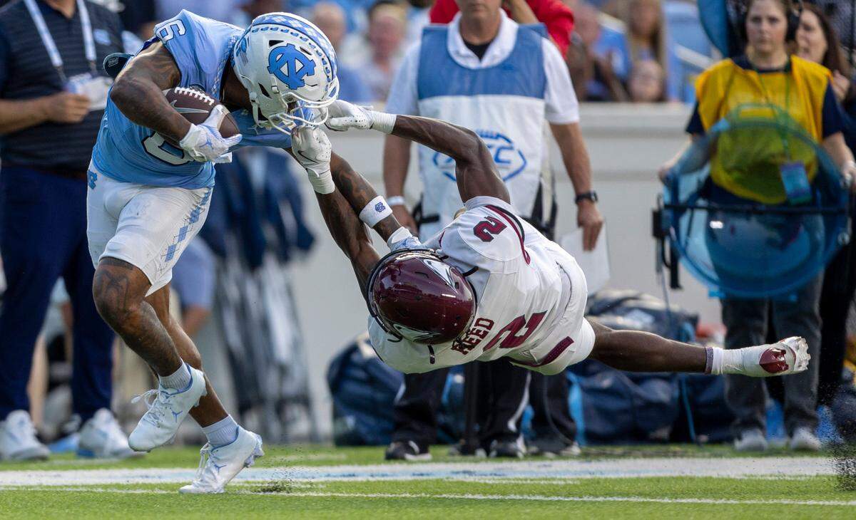 North Carolina Central defensive back Malcolm Reed (2) stops North Carolina wide receiver Nate McCollum (6) with a face mask after a pass reception in the second quarter on Saturday, September 14, 2024 at Kenan Stadium in Chapel Hill, N.C.