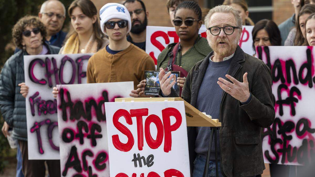 Graeme Robertson, a professor of political science and director of the Center for Slavic, Eurasian and East European Studies at UNC-Chapel Hill, speaks during a rally outside the Spangler Center for Public Health in Chapel Hill on Thursday, Jan. 22, 2026, as the UNC-Chapel Hill Board of Trustees convened a meeting.