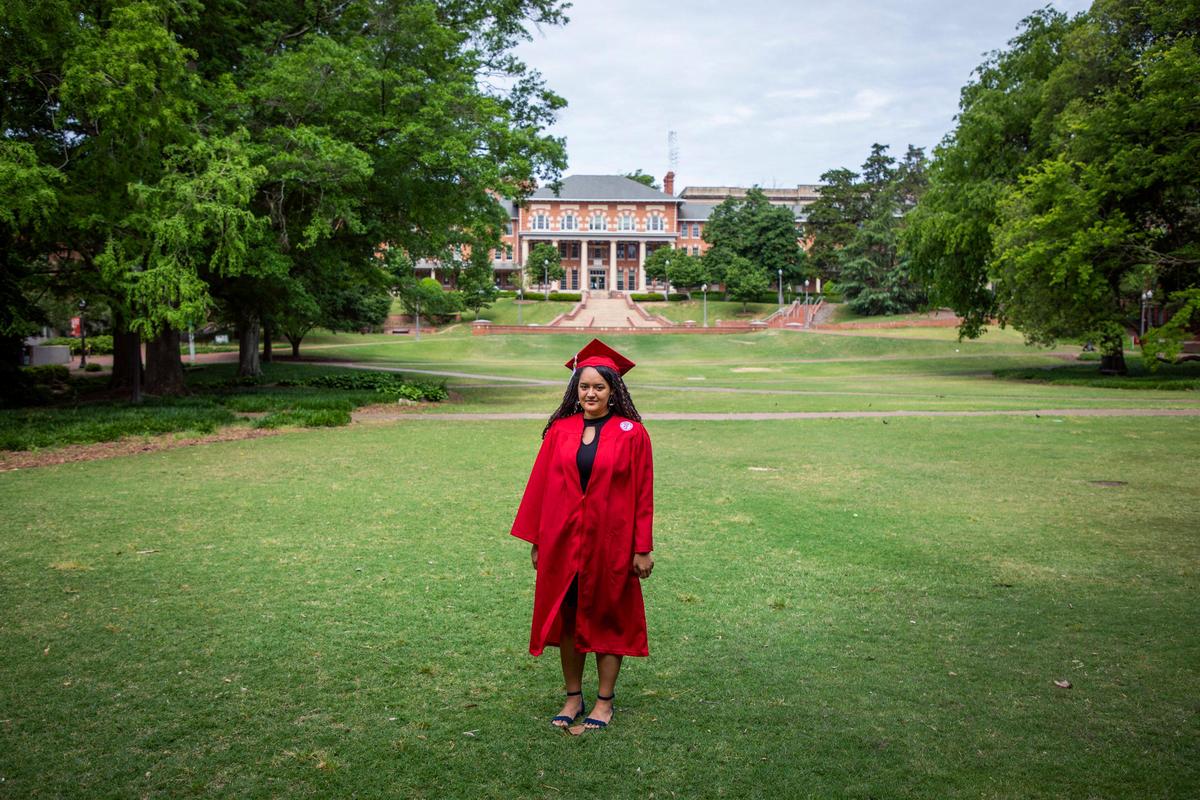 Melia Kendall, 22, stands for a portrait in the cap and gown she wouldÕve worn to her graduation ceremony to celebrate earning her degree in physics at N.C. State University, on Tuesday, May 5, 2020, in Raleigh, N.C.