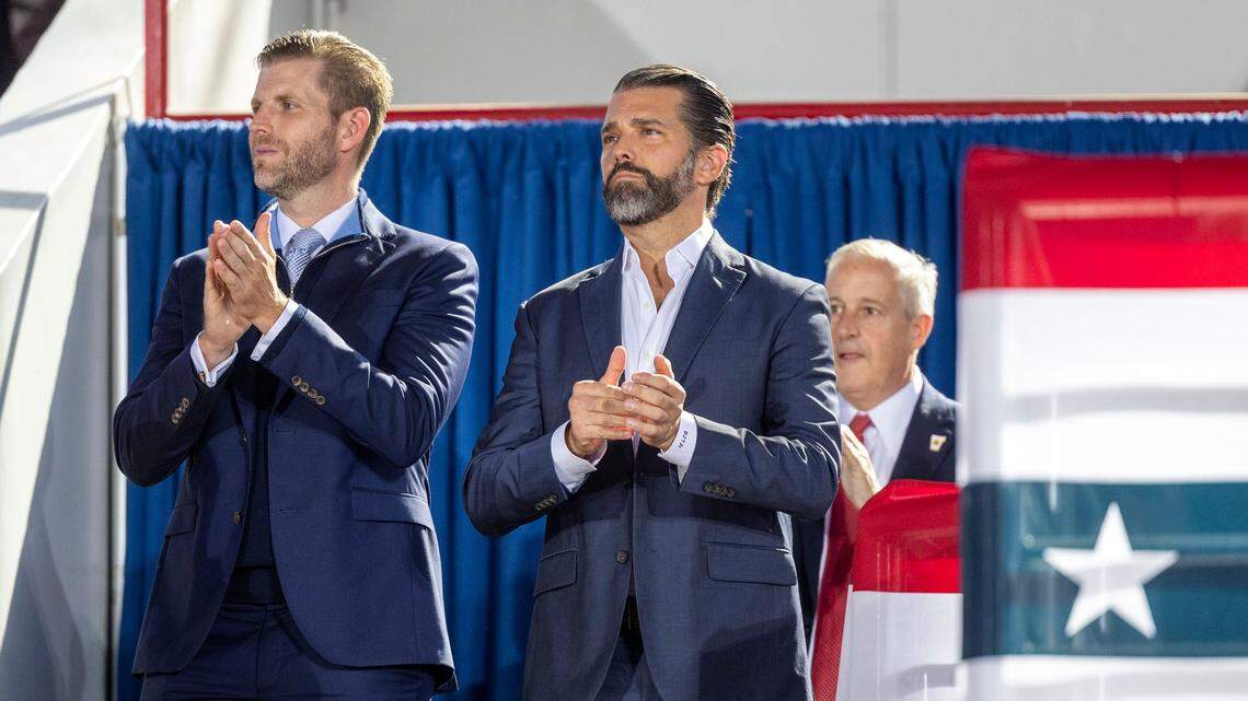 From left, brothers Eric and Don Jr. Trump and Michael Whatley, Chairperson of the Republican National Committee, watch as Republican presidential nominee and former President Donald Trump, speaks during a rally at Dorton Arena in Raleigh on Monday, Nov. 4, 2024, one day before Election Day.