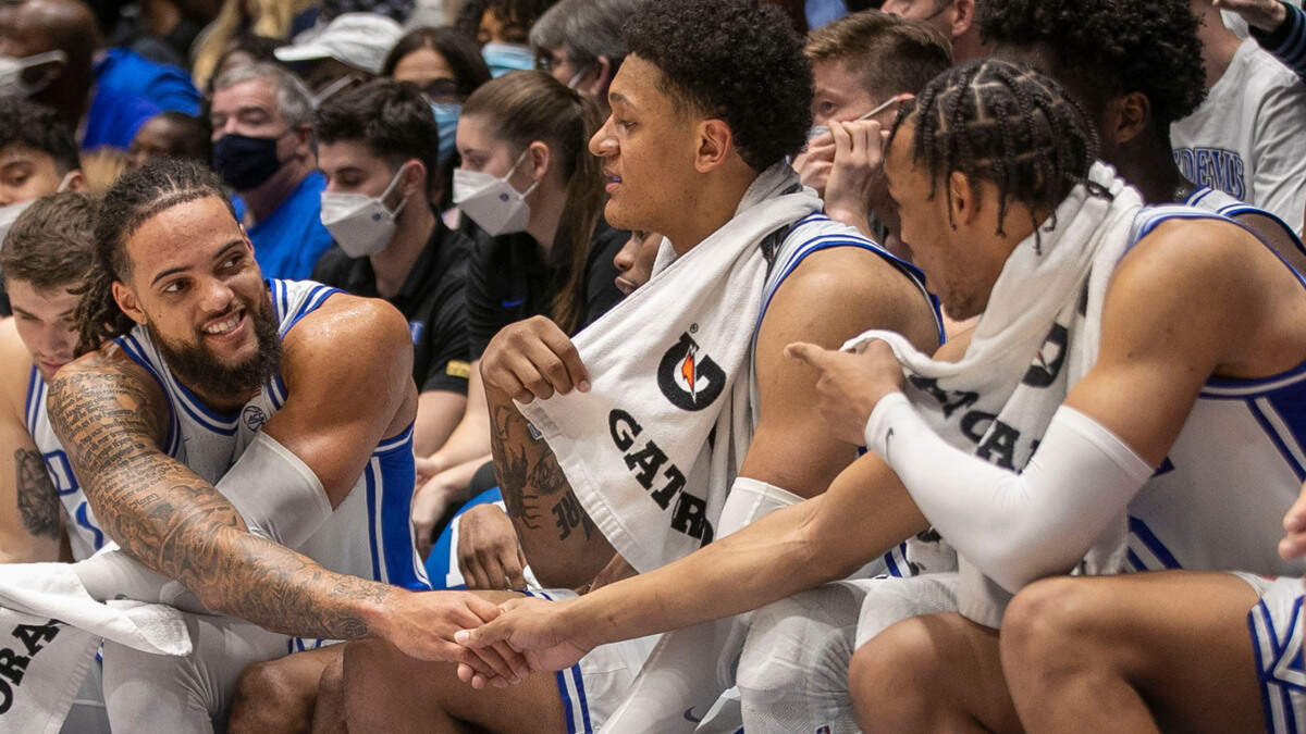 Duke’s Theo John (12) shakes hands with teammate Wendell Moore Jr. (0) during the closing minutes of play against Elon on Saturday, December 18, 2021 at Cameron Indoor Stadium in Durham, N.C.