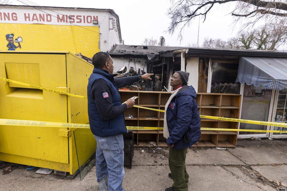 Volunteer contractor James “Monte” Montague, left, and Sylvia Wiggins, longtime director of the Helping Hand Rescue Mission in Raleigh, survey fire damage on Monday, March 2, after a Sunday morning fire tore through the roof and destroyed rooms filled with donated clothing, furniture and toys. The Raleigh Fire Marshal’s Office has declared the building unsafe.
