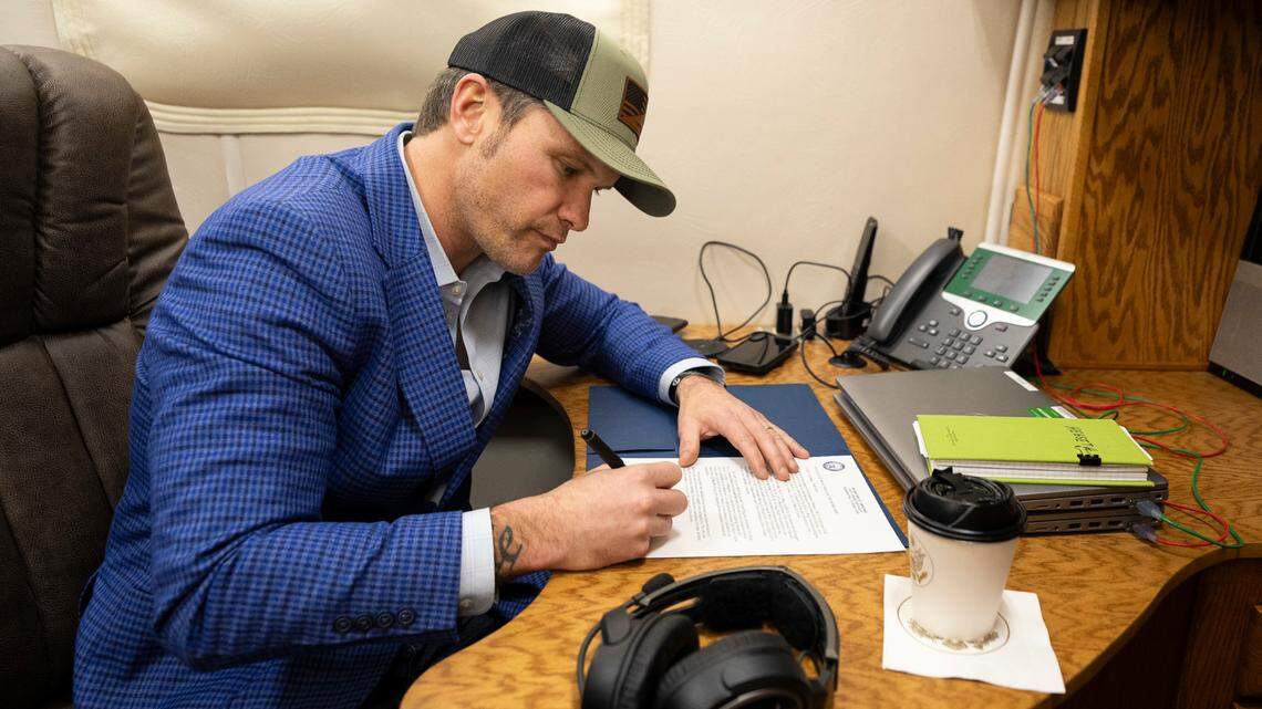 Secretary of Defense Pete Hegseth signs a memorandum reversing the name of Fort Liberty back to Fort Bragg while flying in a C-17 operated by the 300th Airlift Squadron en route to Stuttgart, Germany, Feb. 10, 2025.