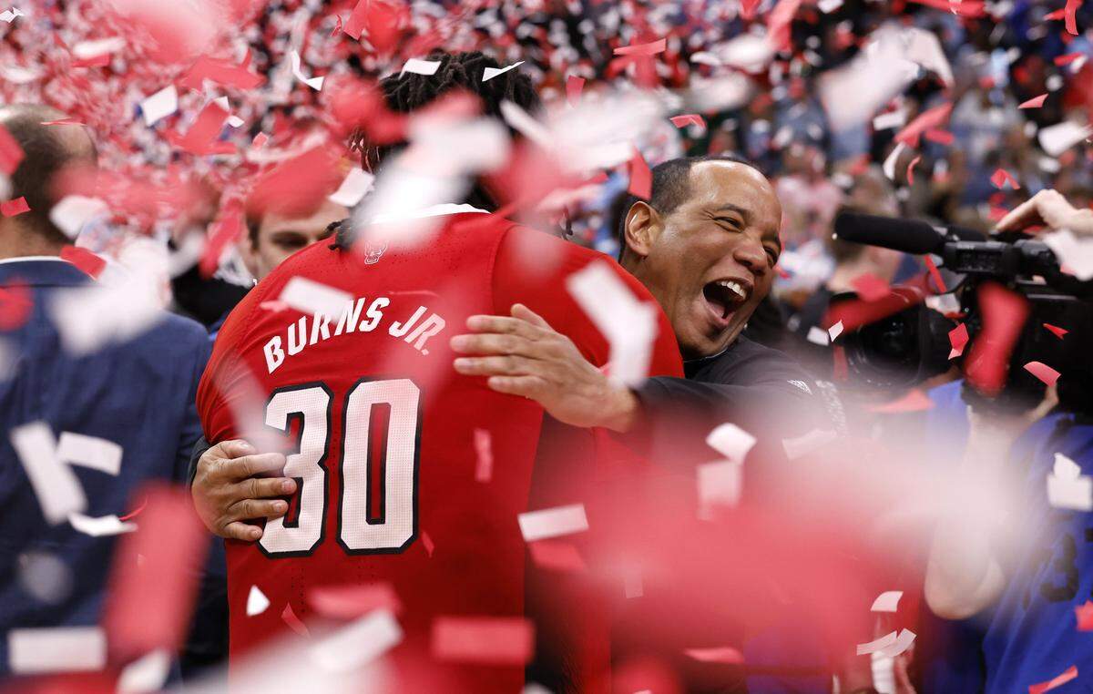 N.C. State's head coach Kevin Keatts hugs DJ Burns Jr. (30) after N.C. State’s 84-76 victory over UNC in the championship game of the 2024 ACC Men’s Basketball Tournament at Capital One Arena in Washington, D.C., Saturday, March 16, 2024.