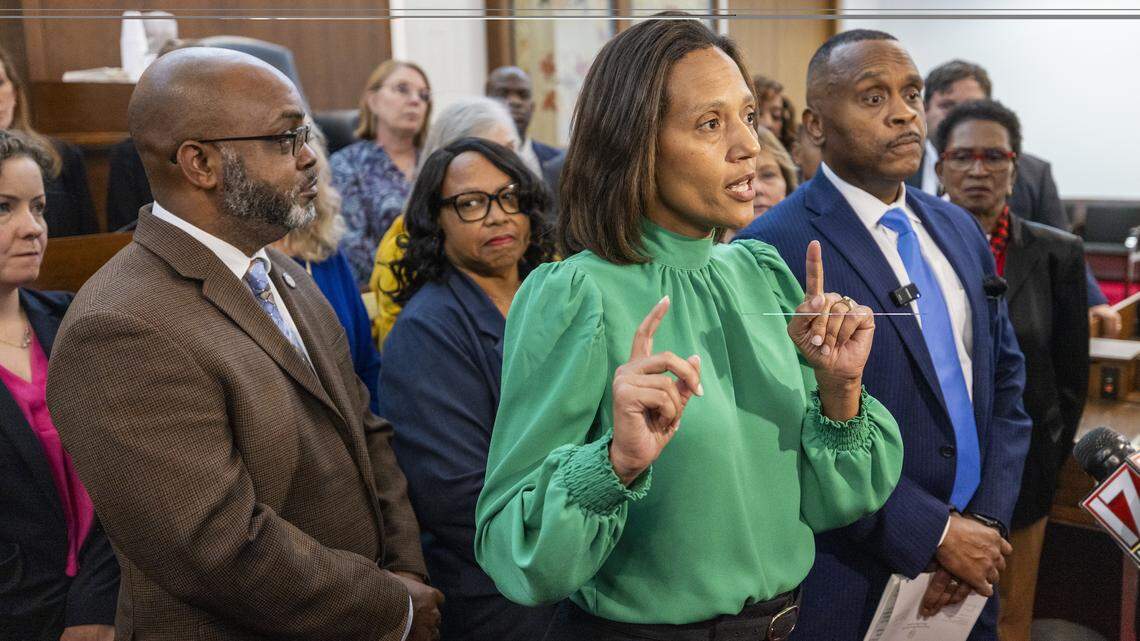 North Carolina Senate Minority Leader Sydney Batch, center, and House Minority Leader Robert Reives, right, lead a news conference with other Democratic House and Senate members on the House floor on Monday, Nov. 17, 2025 at the North Carolina Legislative Building in Raleigh.