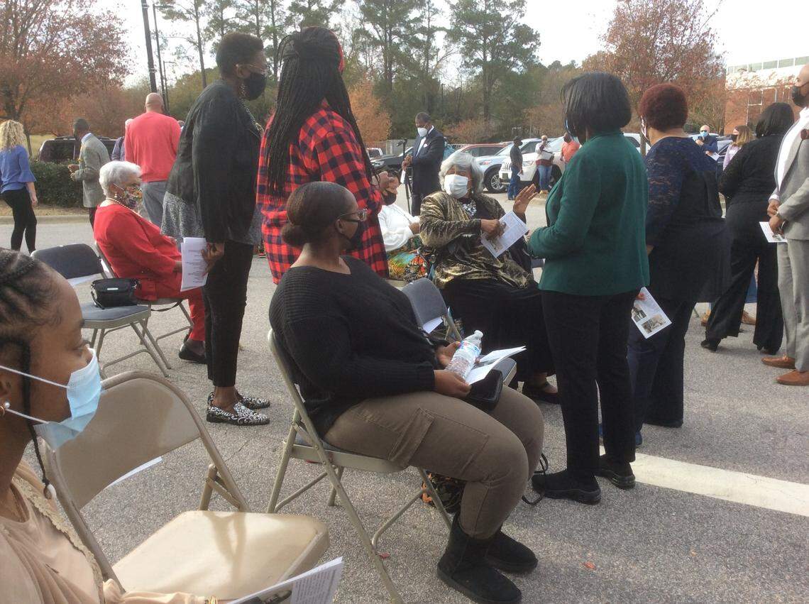 Ann Hunt Smith (seated, at center) speaks with former students of Holly Springs Elementary School before a ceremony dedicating a historic marker Sunday. Hunt Smith’s father W.E. Hunt was a well-loved principal at the school and her mother was a teacher.