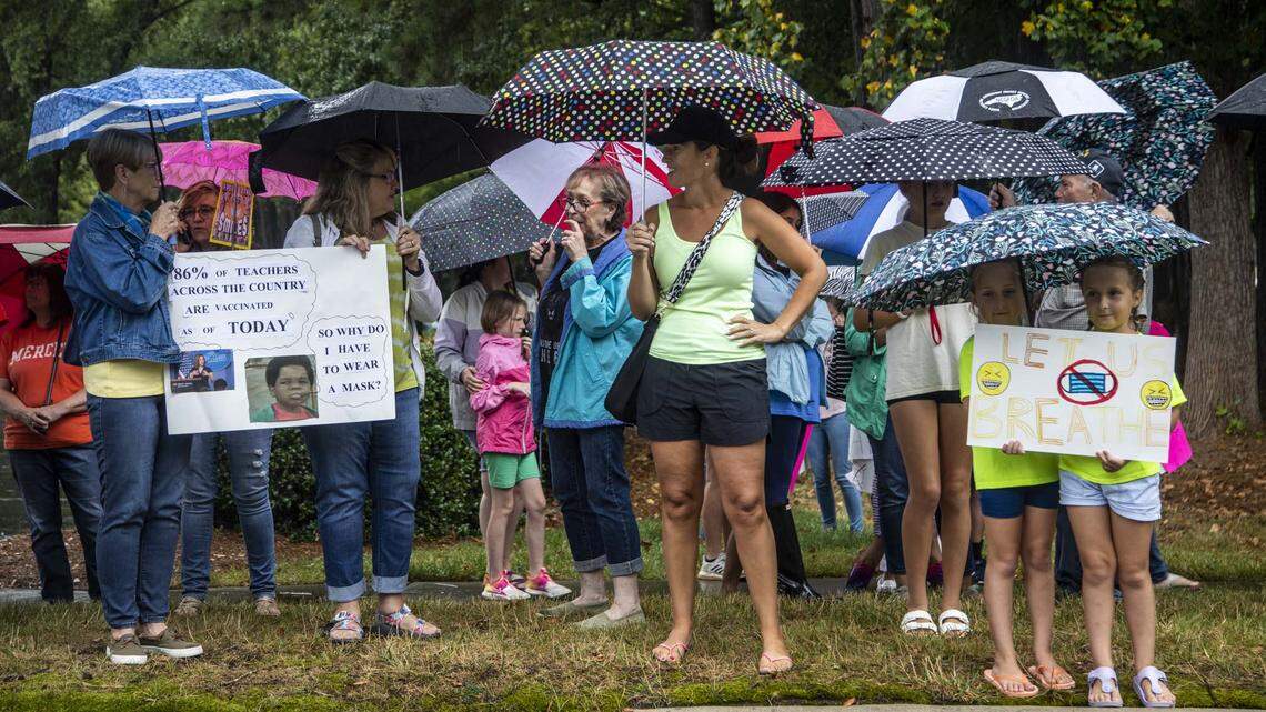 Protesters and counter-protesters demonstrate outside a Wake County Board of Education meeting Tuesday, Aug. 3, 2021 in Cary. The board will vote on a proposal to continue to require face masks in schools. Some parents argue the coverings should be optional.
