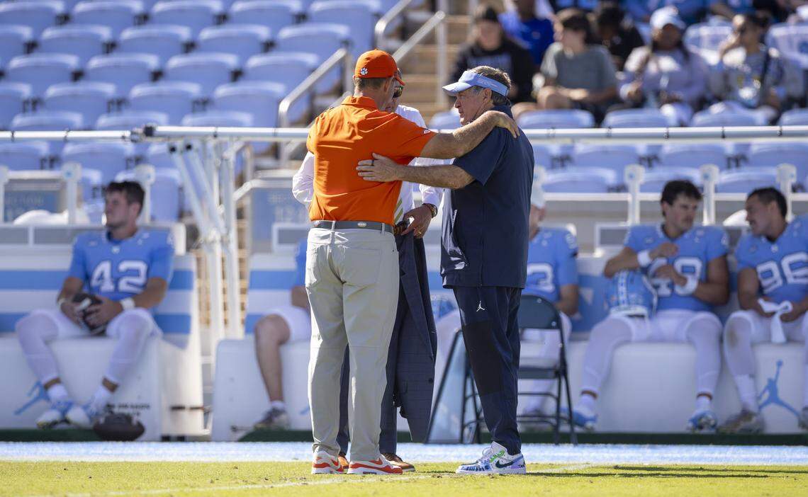 North Carolina coach Bill Belichick talks with Clemson coach Dabo Swinney prior to their game on Saturday, October 4, 2025 at Kenan Stadium in Chapel Hill, N.C.