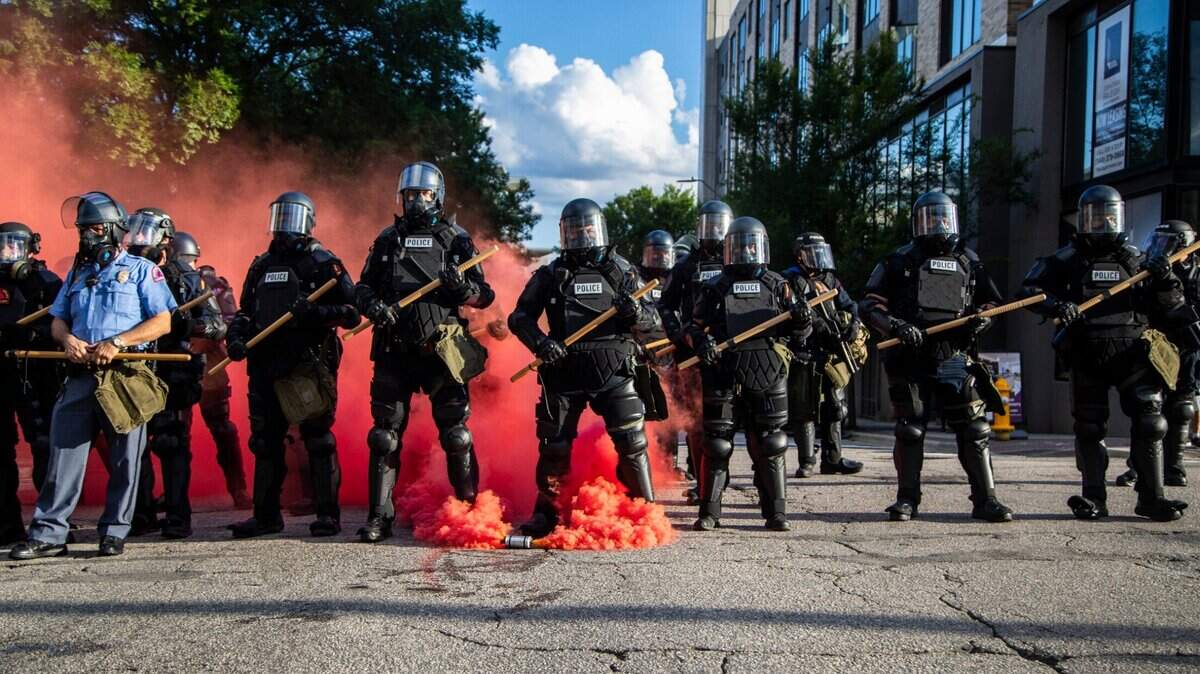 Police in riot gear deploy tear, gas pepper spray and smoke bombs against protesters near the intersection of McDowell and Davie Streets in downtown Raleigh Saturday, May 30, 2020.