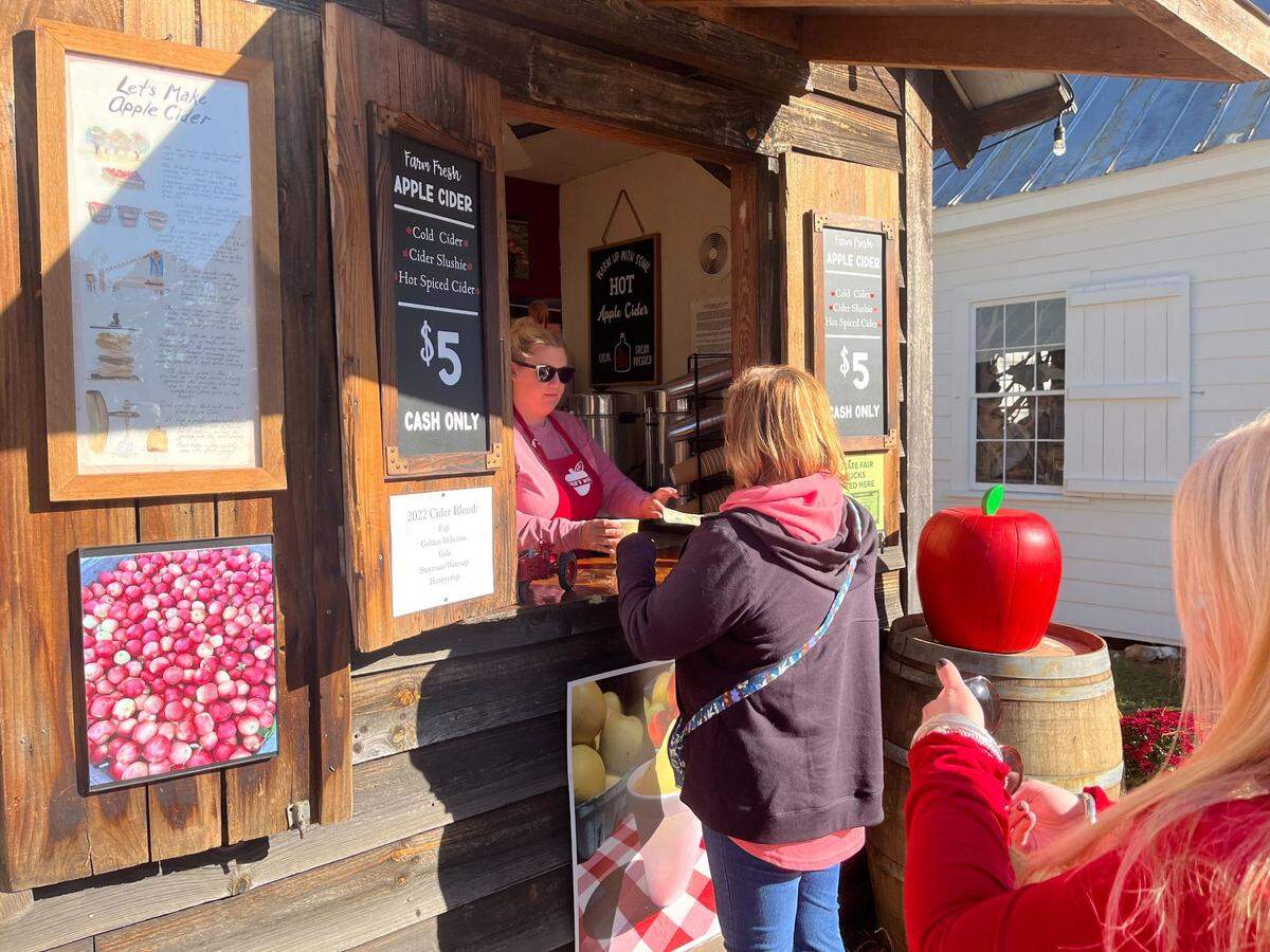 Melissa Enloe runs the Branch Bright Farms apple cider stand at the North Carolina State Fair in Raleigh, NC, on Oct. 18, 2022.