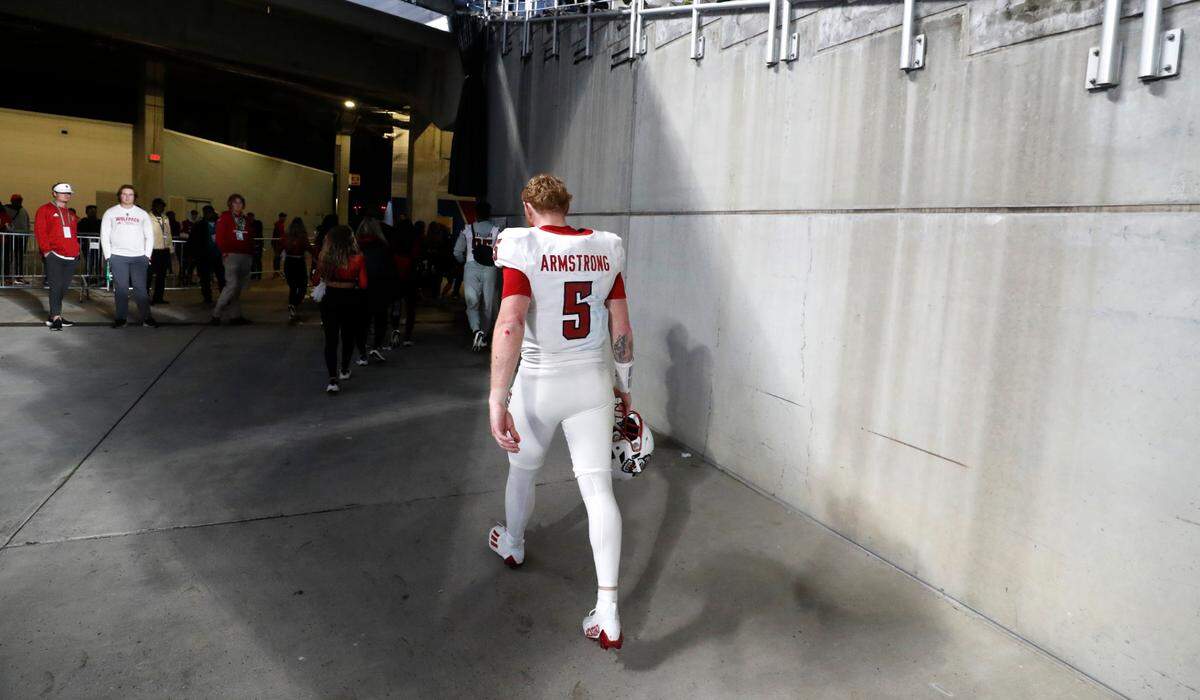 N.C. State quarterback Brennan Armstrong (5) walks off the field after Kansas State’s 28-19 victory over N.C. State in the Pop-Tarts Bowl at Camping World Stadium in Orlando, Fla., Thursday, Dec. 28, 2023.