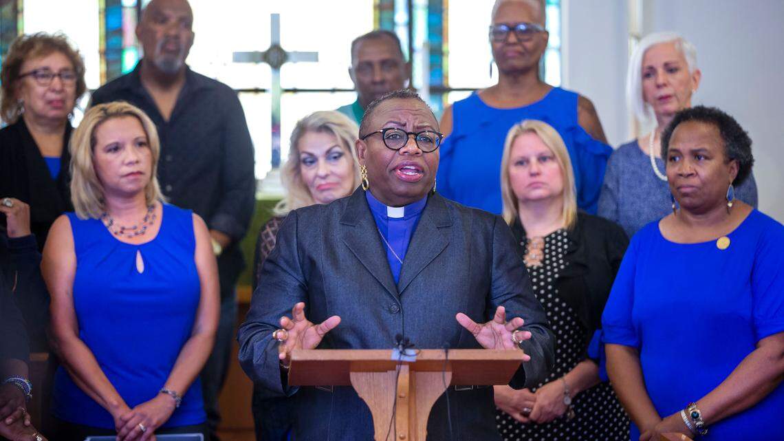 Women wear blue in support of sexual harassment victim as Bishop Tonyia Rawls calls for the national NAACP to expel a North Carolina NAACP member who was forced to resign his position following sexual harassment charges in a photo taken in Greensboro, NC on Sept. 16, 2019. (H. Scott Hoffmann/News & Record)