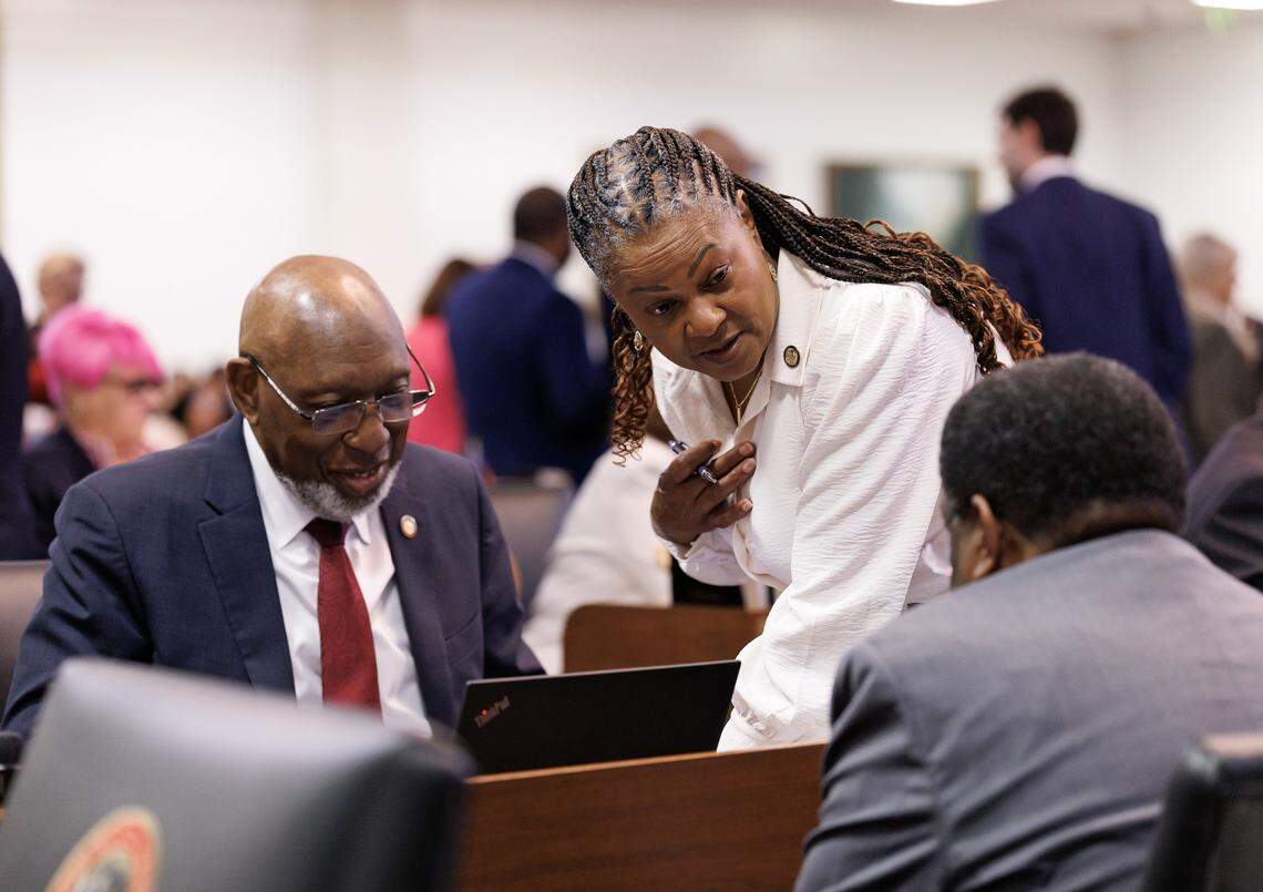 Reps. Shelly Willingham, Carla Cunningham and Garland Pierce talk during a break in session in the House chamber of the Legislative Building on Wednesday, May 21, 2025, in Raleigh, N.C.