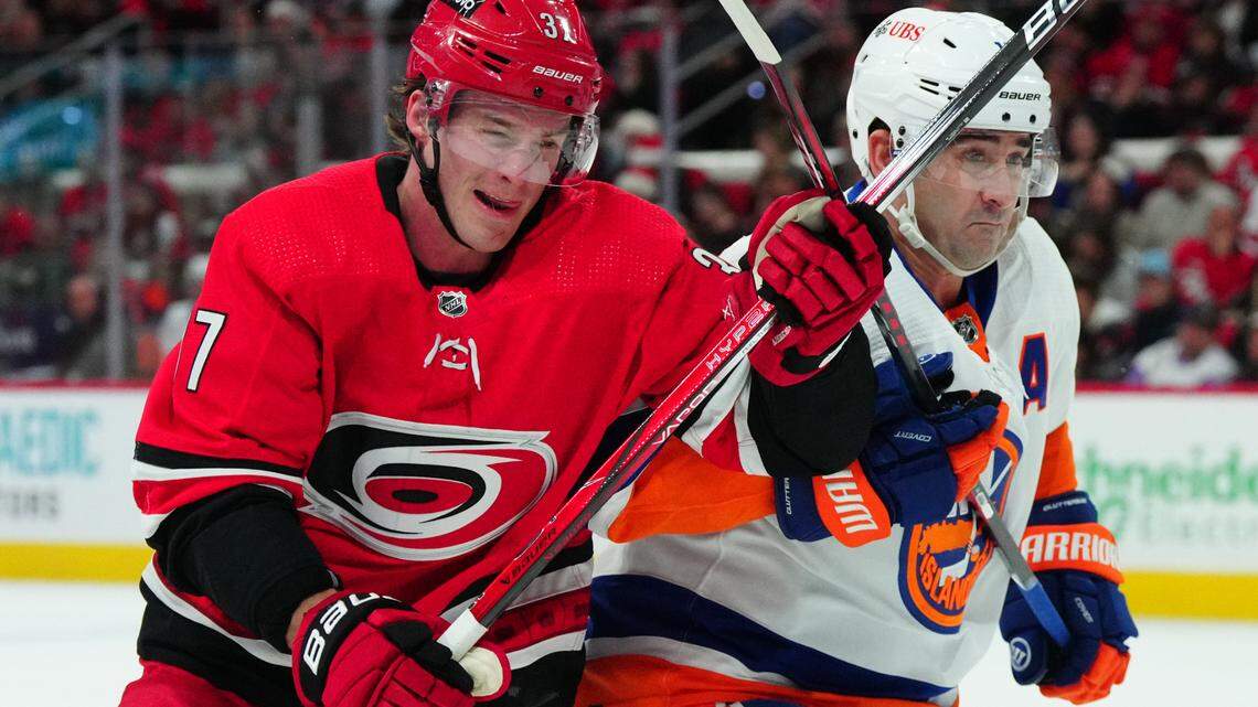 Dec 23, 2023; Raleigh, North Carolina, USA; Carolina Hurricanes right wing Andrei Svechnikov (37) and New York Islanders right wing Cal Clutterbuck (15) battle for position during the first period of a Dec. 23, 2023 game in Raleigh, N.C. The two teams will meet in the first round of the NHL playoffs.