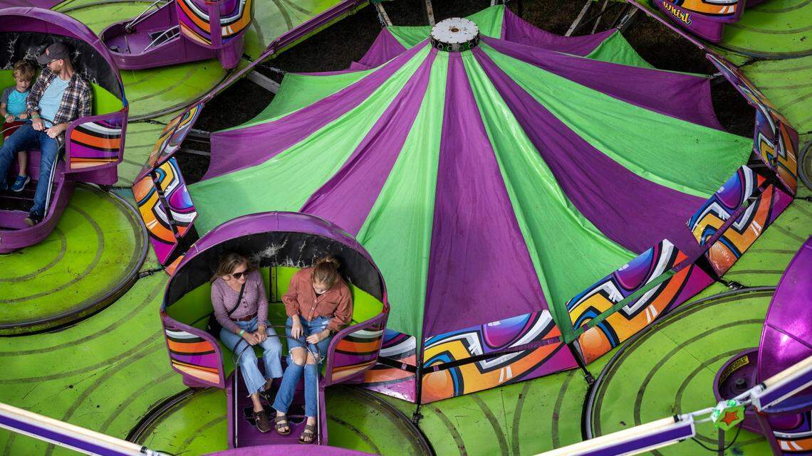 Fairgoers enjoy the Tilt-A-Whirl on the opening day of the 2022 North Carolina State Fair on Thursday, October 13, 2022 in Raleigh, N.C.