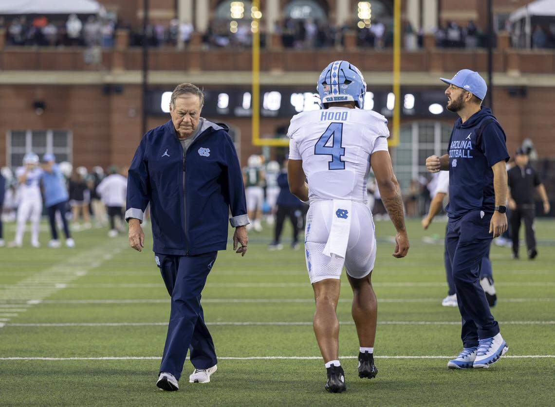 North Carolina coach Bill Belichick, running back Caleb Hood (4), quarterbacks coach Matt Lombardi, warm up for the Tar Heels’ game against UNC Charlotte on Saturday, September 6, 2025 at Jerry Richardson Stadium in Charlotte, N.C. 