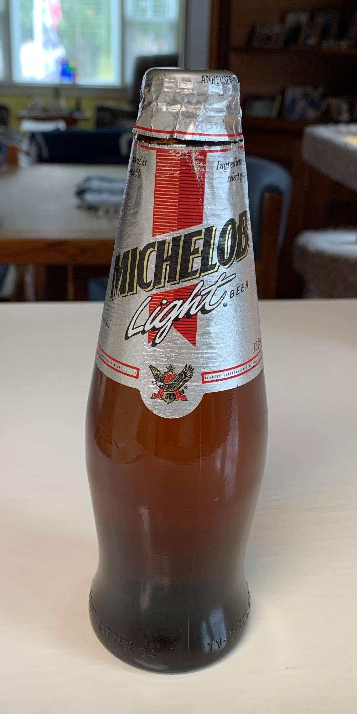 Duke fan Partha Howell and UNC fan Chris Hoke have been passing this bottle of Michelob Light back and forth as a rivalry trophy since 1994. With the retirements of Roy Williams and Mike Krzyzewski, they’re retiring the rivalry beer as well.