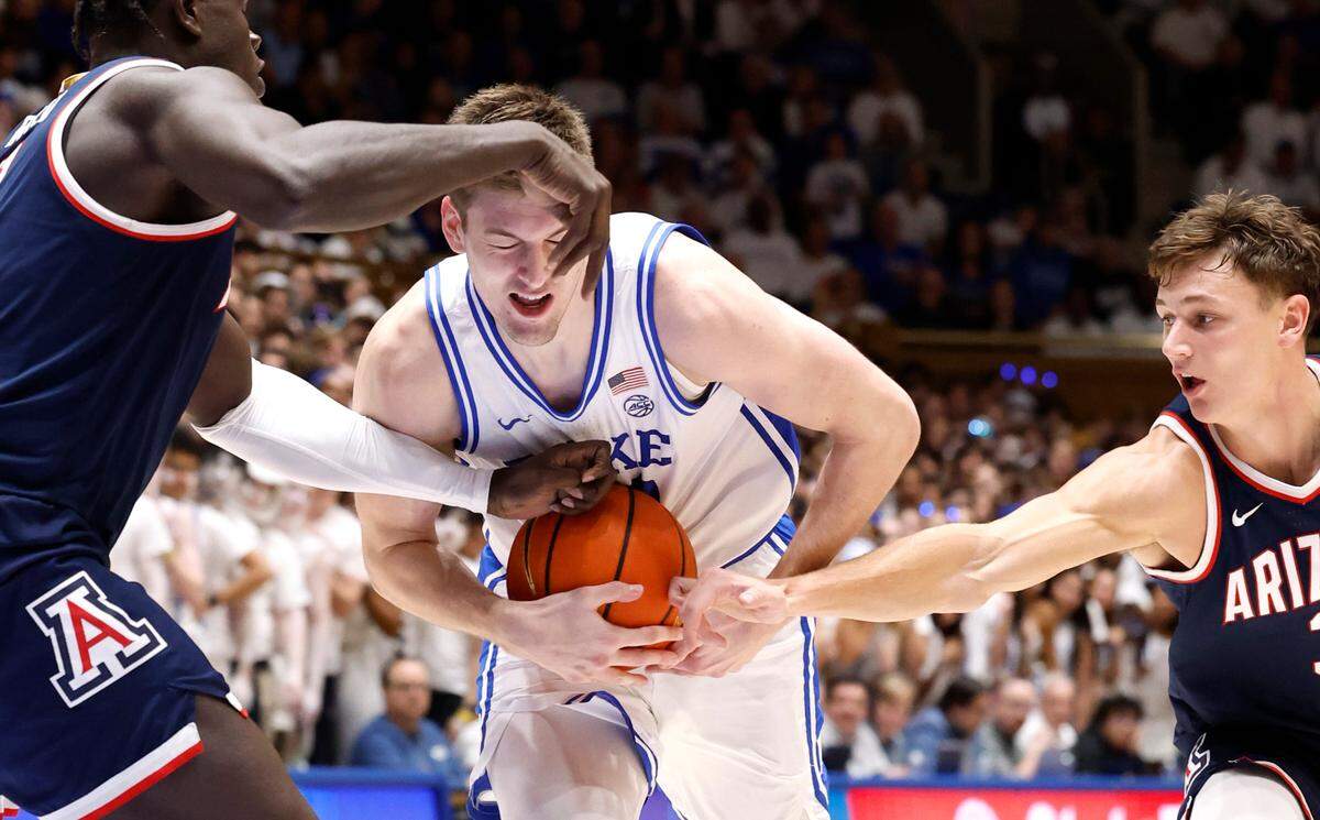 Duke’s Kyle Filipowski (30) drives between Arizona’s Oumar Ballo (11) and Pelle Larsson (3) during the second half of Arizona’s 78-73 victory over Duke at Cameron Indoor Stadium in Durham, N.C., Friday, Nov. 10, 2023.