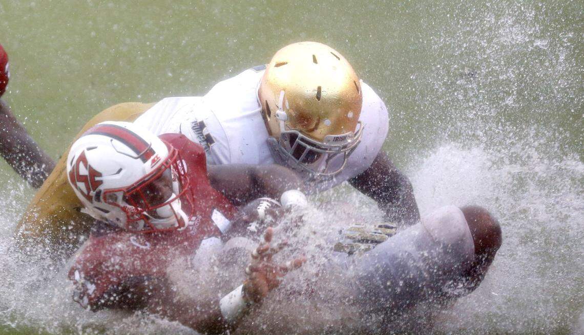 N.C. State running back Matt Dayes (21) slides on the ground after being tackled by Notre Dame linebacker Te’von Coney (4) during the second half of N.C. State’s 10-3 victory over Notre Dame at Carter-Finley Stadium in Raleigh, N.C., Saturday, Oct. 8, 2016.