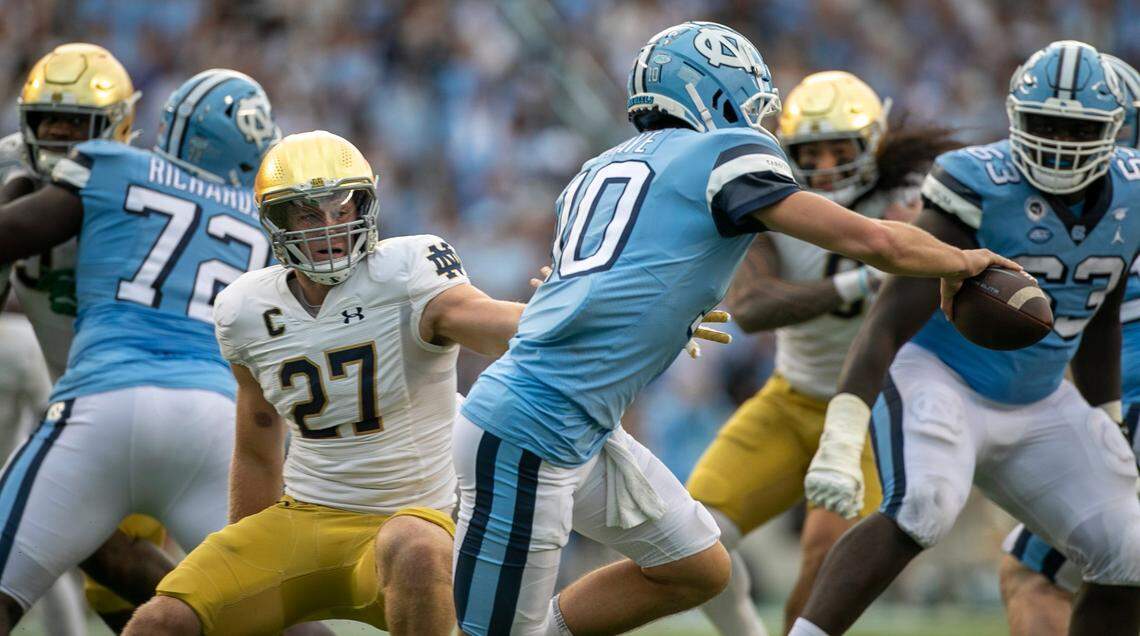 Notre Dame’s J.D. Bertrand (27) pressures North Carolina quarterback Drake Maye (10), causing a fumble in the third quarter on Saturday, September 24, 2022 at Kenan Stadium in Chapel Hill, N.C. Notre Dame’s Justin Ademilola (9) recovered the fumble.