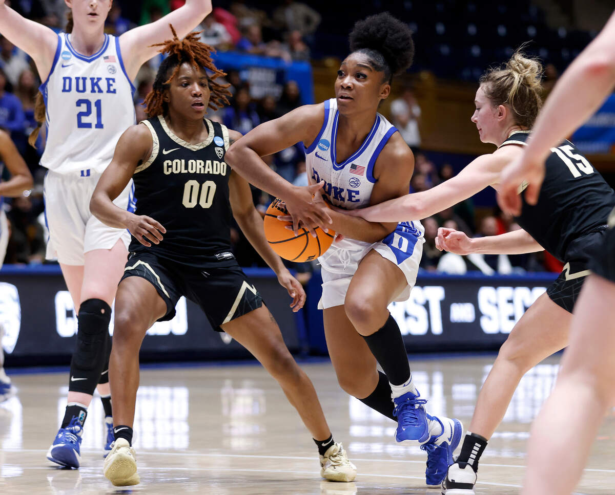 Duke’s Shayeann Day-Wilson drives between Colorado’s Jaylyn Sherrod and Kindyll Wetta during overtime of the Blue Devils’ 61-53 loss to Colorado in an NCAA Tournament second round game at Cameron Indoor Stadium on Monday, March 20, 2023, in Durham, N.C.
