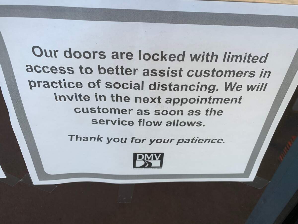 A sign on the door of the Division of Motor Vehicles driver’s license office on Avent Ferry Road in Raleigh. The DMV is seeing customers by appointment only.
