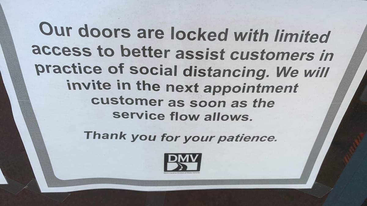 A sign on the door of the Division of Motor Vehicles driver’s license office on Avent Ferry Road in Raleigh. The DMV is seeing customers by appointment only.