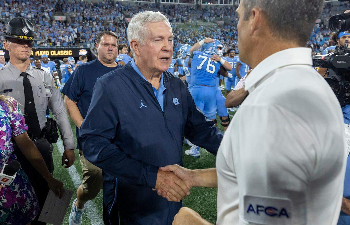 North Carolina coach Mack Brown is congratulated by South Carolina coach Shane Beamer following the Tar Heels’ 31-17 victory on Saturday September 2, 2023 at Bank of America Stadium in Charlotte, N.C.