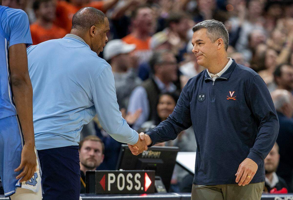 North Carolina coach Hubert Davis congratulates Virginia coach Tony Bennett following the Cavaliers’ 65-58 victory on Tuesday, January 10, 2023 at John Paul Jones Arena in Charlottesville, Va.
