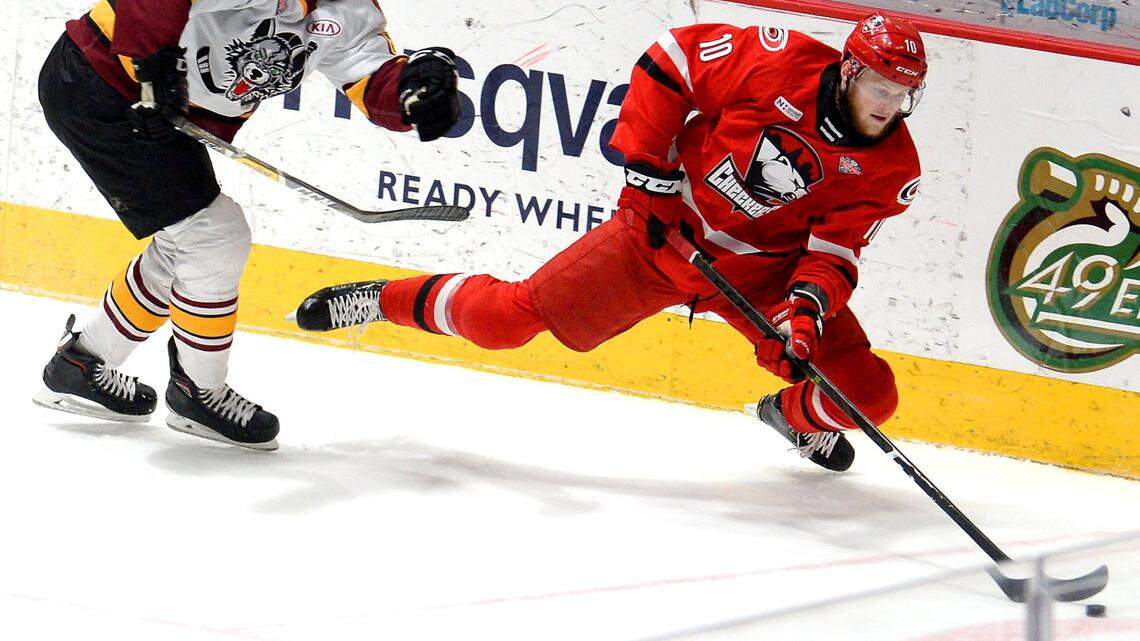 Charlotte Checkers center Steven Lorentz, right, fights to maintain control of the puck while battling Chicago Wolves Griffin Reinhart, left, during first period action on Sunday, June 2, 2019 at Bojangles’ Coliseum in Charlotte, NC.