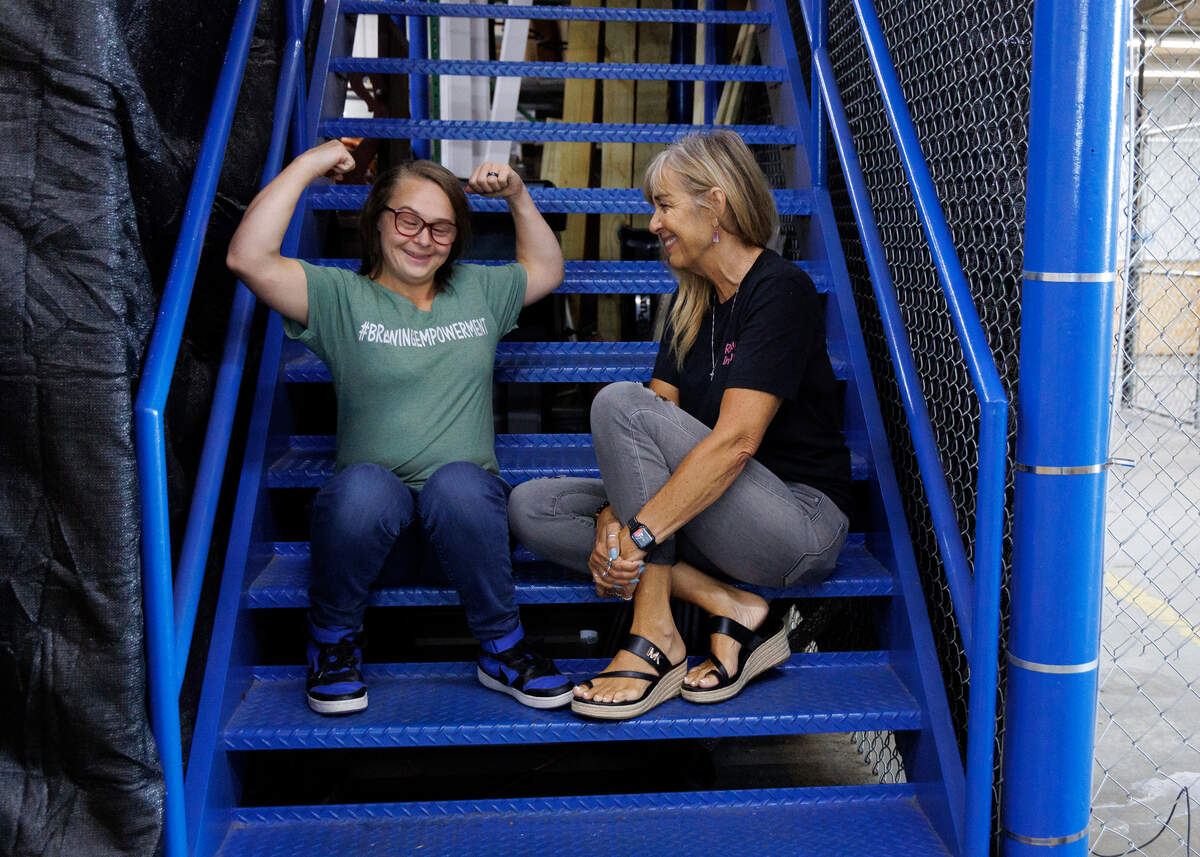 Gabi Angelini flexes her muscles while posing for a portrait with her mother, Mary Angelini, on Friday, June 20, 2025, in Raleigh, N.C. The Angelinis are co-founders of Gabi’s PALS (Packaging, Assembling, Labeling and Shipping), an organization which is committed to employing individuals with disabilities.
