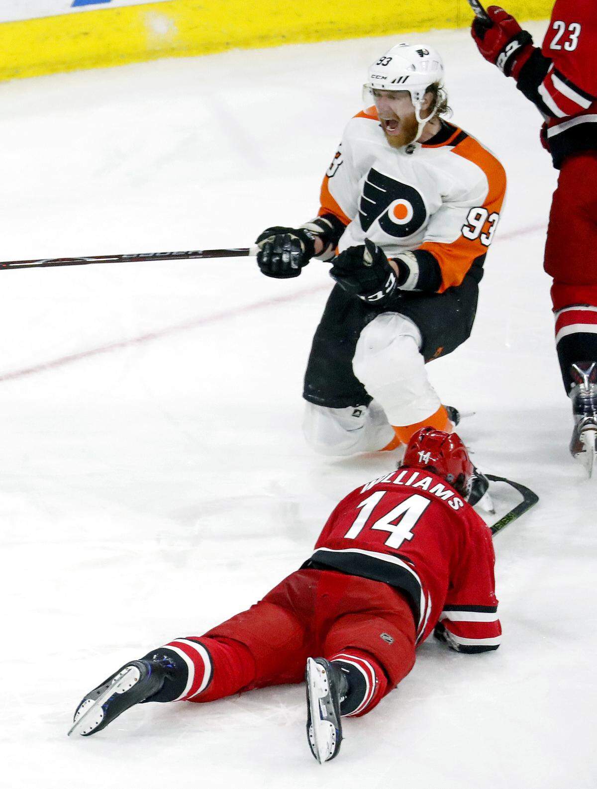 The Flyers' Jakub Voracek (93) celebrates his goal while the Canes Justin Williams (14) looks on during the third period of an NHL game played between the Carolina Hurricanes and the Philadelphia Flyers at PNC Arena in Raleigh, N.C. on March 17, 2018.  The Flyers beat the Canes 4-2.