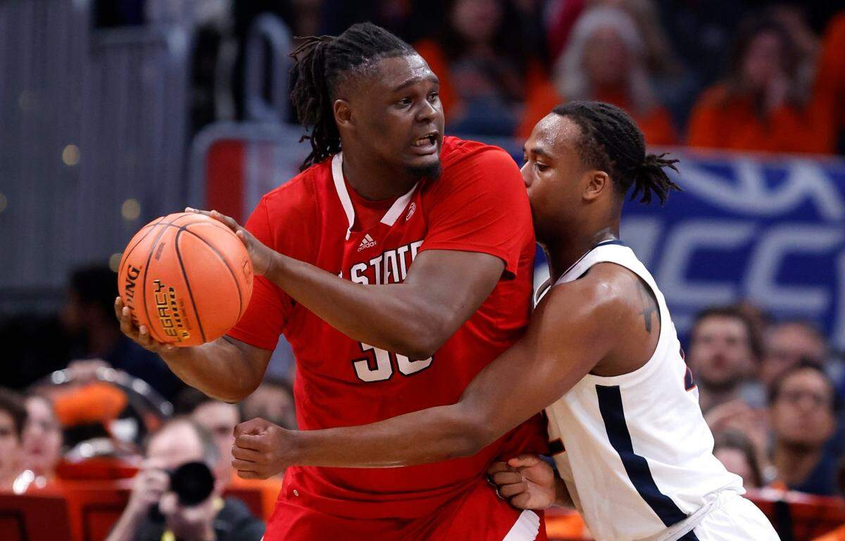 N.C. State’s DJ Burns Jr. (30) works around Virginia’s Jordan Minor (22) during the first half of N.C. State’s game against Virginia in the semifinals of the 2024 ACC Men’s Basketball Tournament at Capital One Arena in Washington, D.C., Friday, March 15, 2024.
